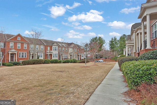 view of community with a residential view and a lawn