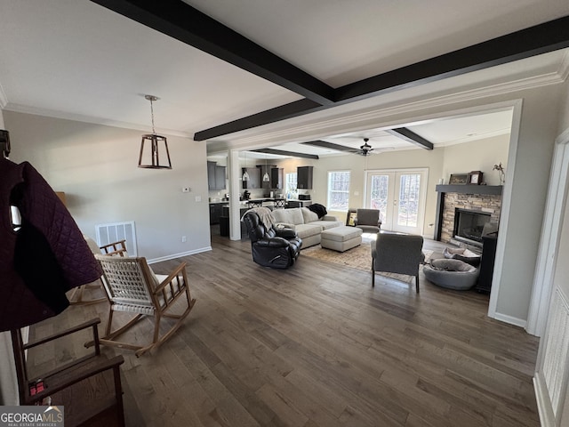 living room featuring dark wood-style floors, beamed ceiling, baseboards, and a ceiling fan