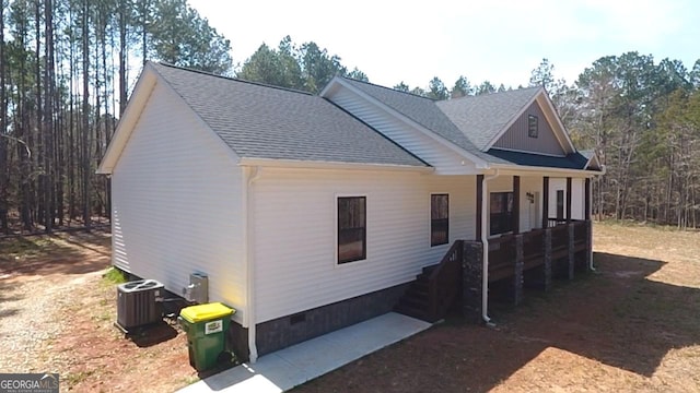 view of front of home featuring crawl space, central AC, a shingled roof, and a porch