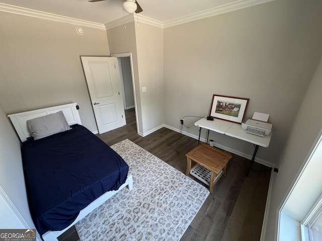 bedroom featuring a ceiling fan, crown molding, baseboards, and wood finished floors