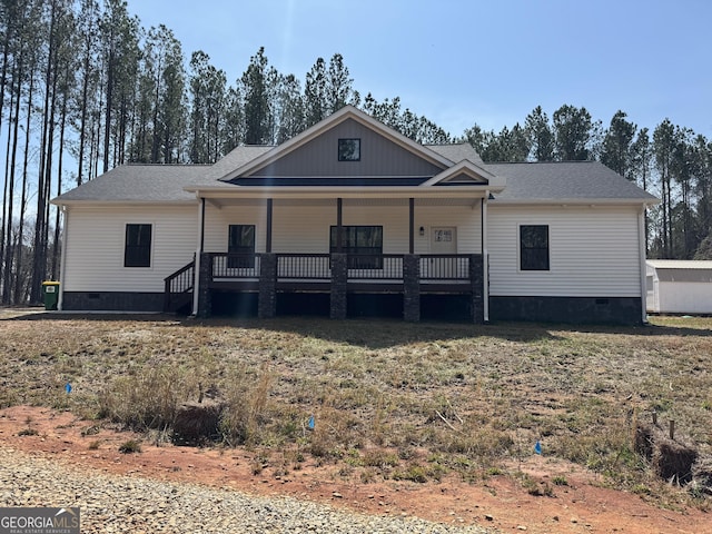 view of front of house featuring crawl space, roof with shingles, and covered porch