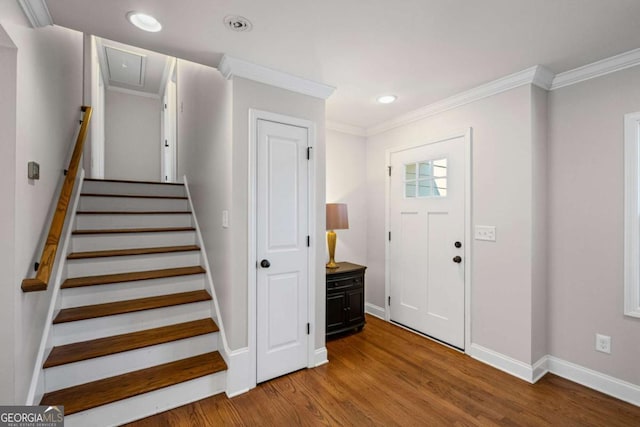 entryway with recessed lighting, wood finished floors, baseboards, and ornamental molding