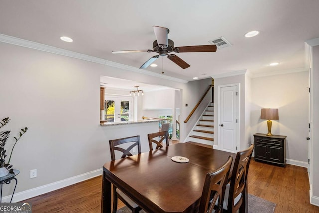 dining room featuring visible vents, baseboards, wood finished floors, and a ceiling fan