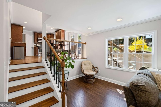 stairs featuring recessed lighting, ornamental molding, baseboards, and wood finished floors