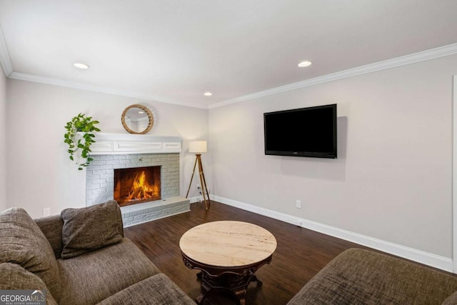 living room with a fireplace, wood finished floors, baseboards, and ornamental molding