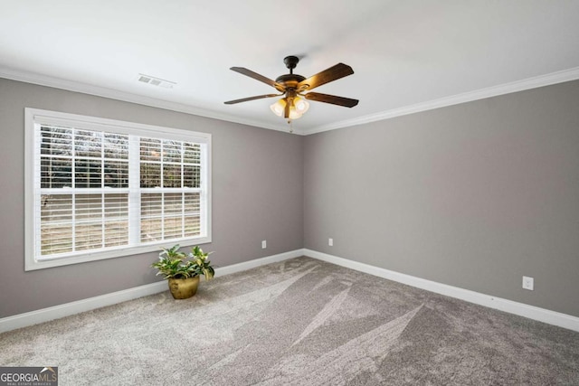 unfurnished room with carpet flooring, baseboards, ornamental molding, and a ceiling fan