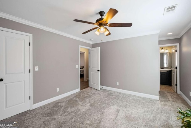 unfurnished bedroom with visible vents, baseboards, ensuite bath, ornamental molding, and light colored carpet