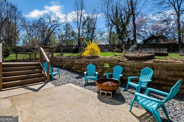 view of patio / terrace featuring an outdoor fire pit and a fenced backyard