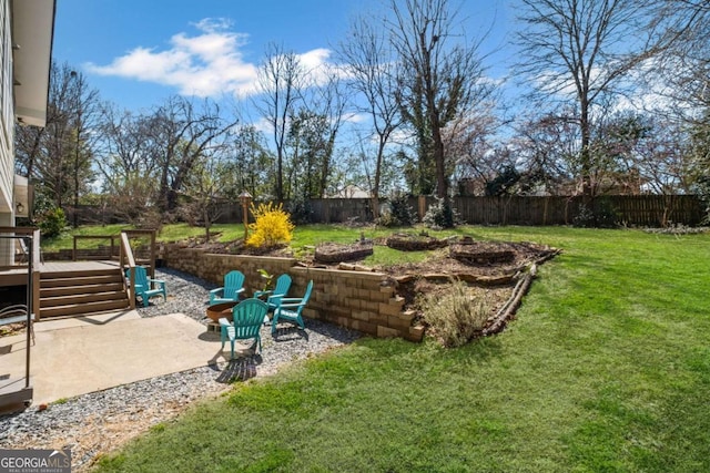 view of yard with a patio, a fire pit, and a fenced backyard