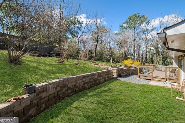 view of yard featuring a wooden deck and fence