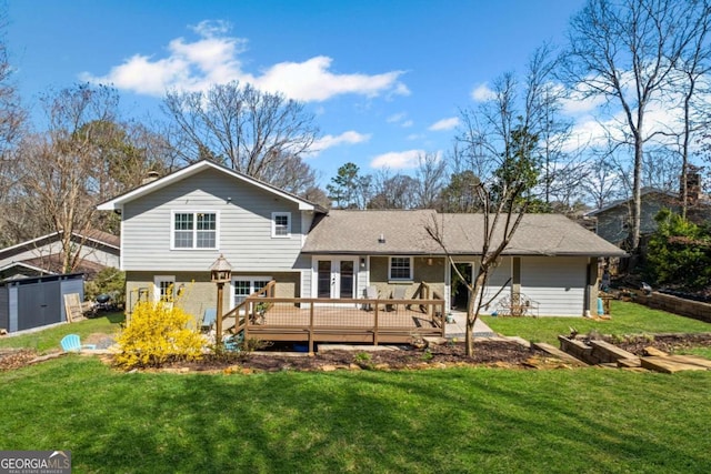 rear view of property with a deck and a yard