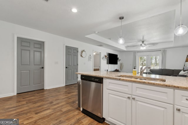 kitchen with a sink, open floor plan, a raised ceiling, dishwasher, and dark wood-style flooring