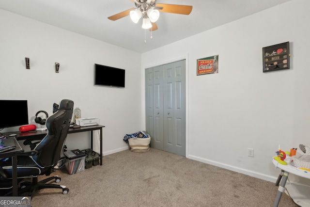 office space with ceiling fan, baseboards, and carpet