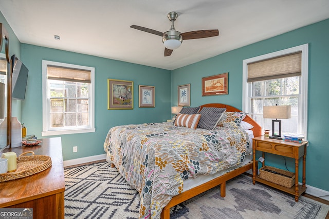 bedroom featuring a ceiling fan and baseboards