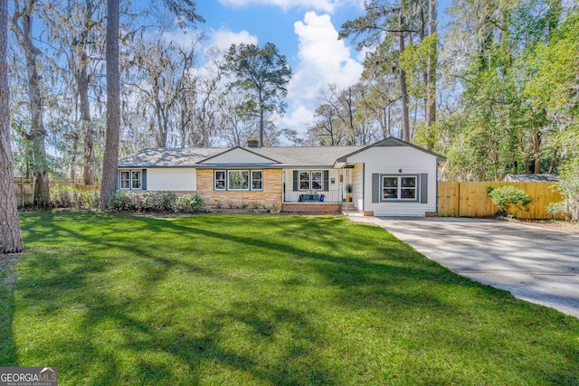 ranch-style home with a front yard and fence