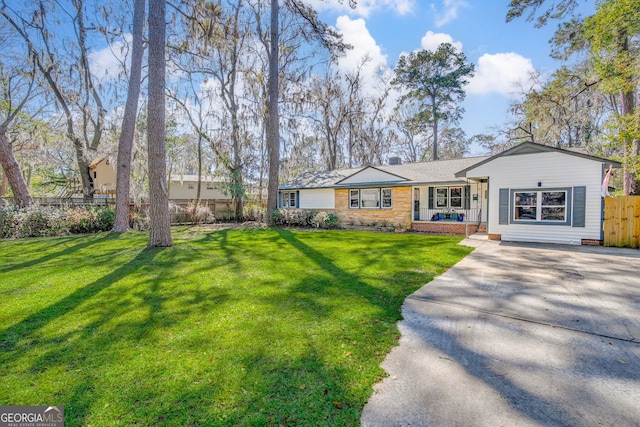 single story home featuring driveway, a front yard, and fence