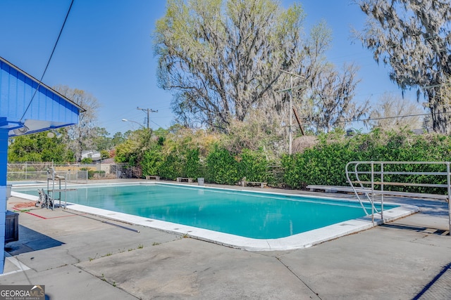 view of pool with a fenced in pool, a patio, and fence