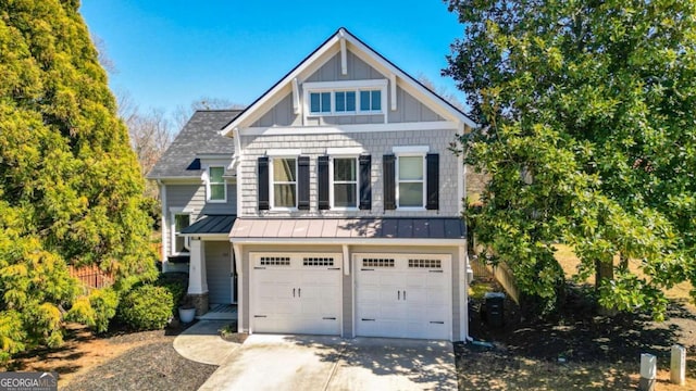 craftsman house with a standing seam roof, board and batten siding, concrete driveway, an attached garage, and metal roof