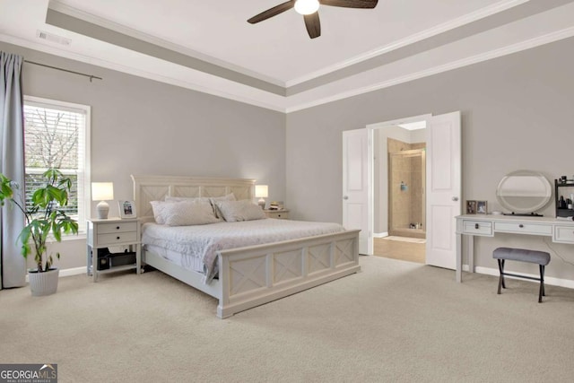 bedroom with a raised ceiling, light colored carpet, visible vents, and ornamental molding