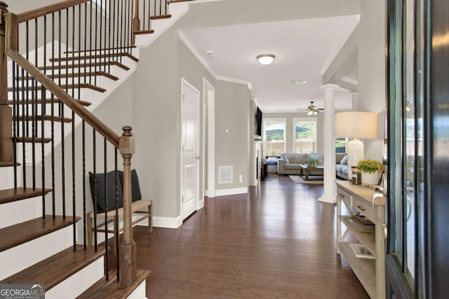 entrance foyer with visible vents, crown molding, ceiling fan, stairway, and wood finished floors