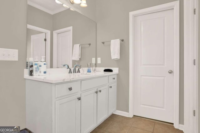 bathroom featuring vanity, tile patterned floors, crown molding, and baseboards