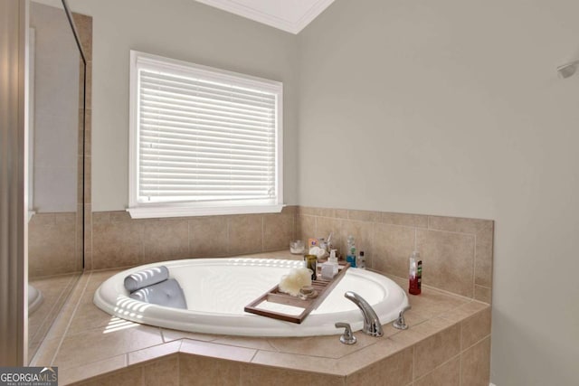 bathroom with a garden tub and ornamental molding