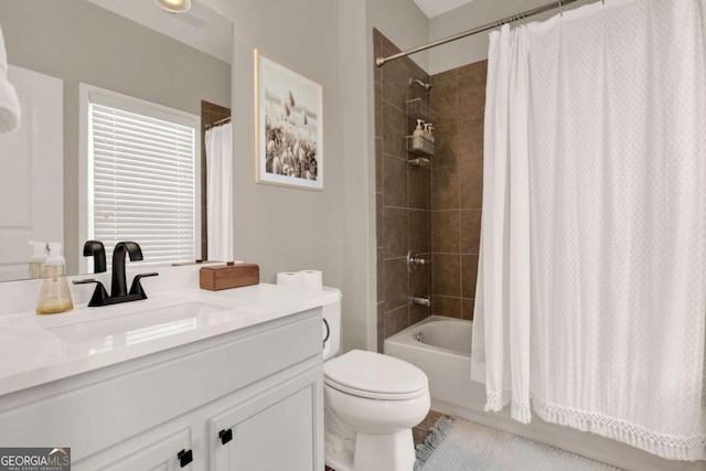 full bath featuring vanity, shower / tub combo, and toilet