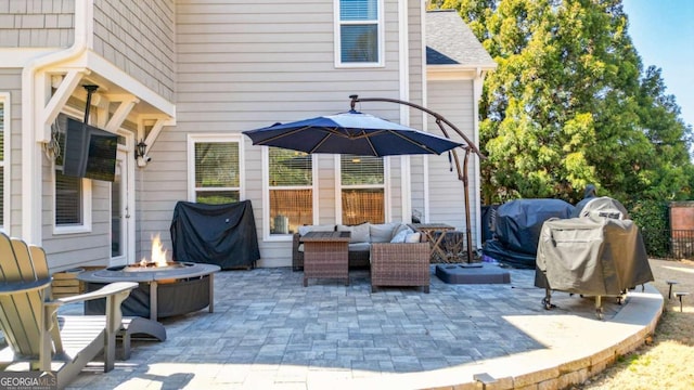 view of patio / terrace with an outdoor living space with a fire pit and area for grilling