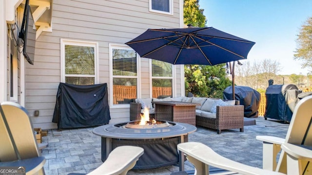 view of patio featuring an outdoor living space with a fire pit and grilling area