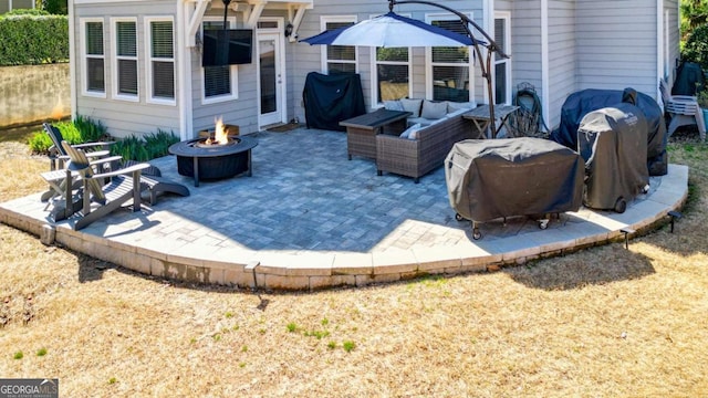 view of patio featuring an outdoor living space with a fire pit and grilling area