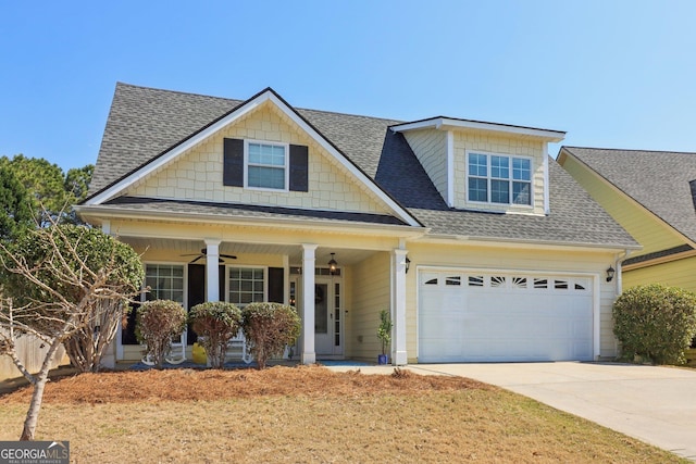 view of front of home with a ceiling fan, covered porch, a shingled roof, concrete driveway, and a garage