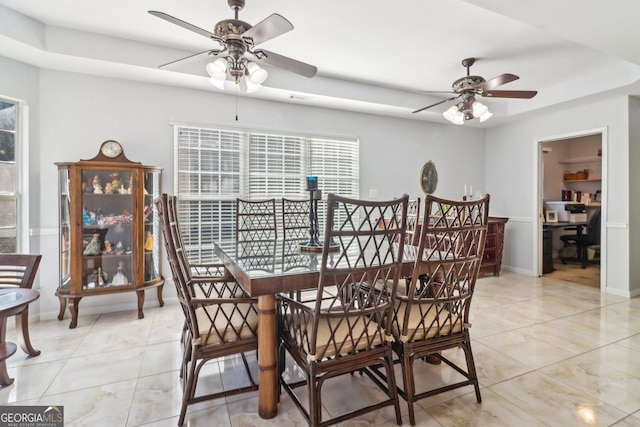 dining room with light tile patterned floors, baseboards, and ceiling fan