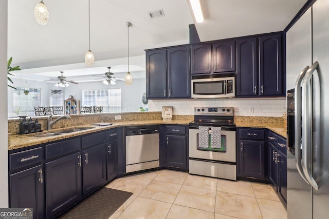 kitchen with a sink, light stone countertops, visible vents, and stainless steel appliances