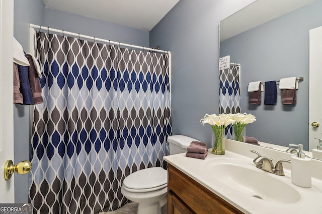 full bathroom featuring vanity, curtained shower, and toilet