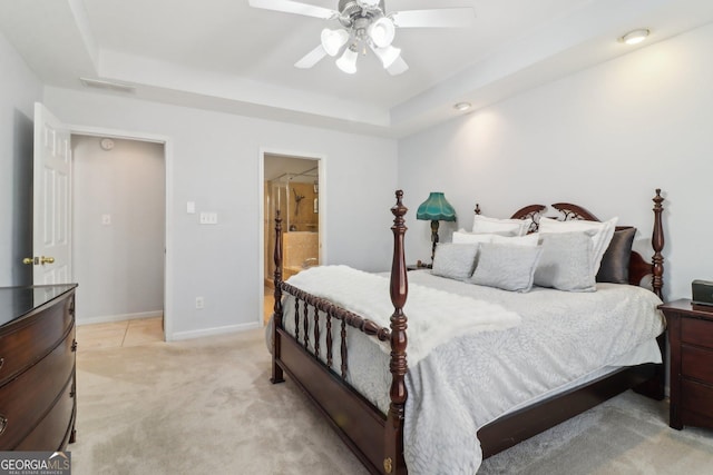 bedroom featuring visible vents, baseboards, light carpet, a raised ceiling, and a ceiling fan