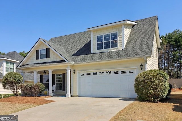 view of front of home with a ceiling fan, an attached garage, driveway, and a shingled roof