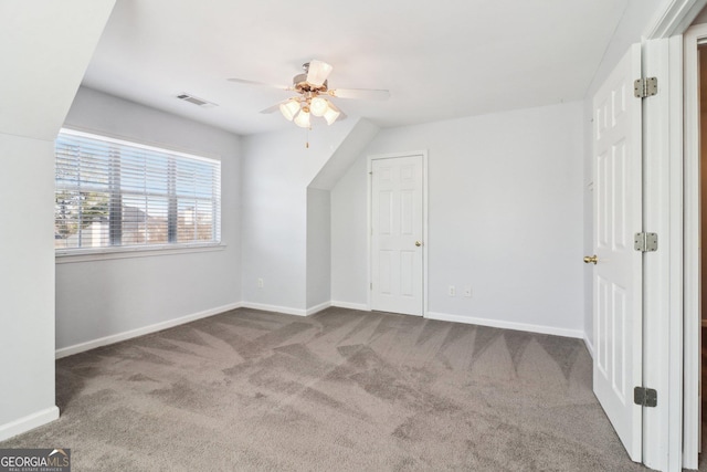 additional living space featuring visible vents, baseboards, ceiling fan, and carpet floors