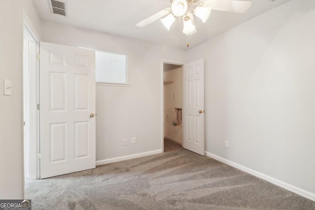 unfurnished bedroom featuring visible vents, carpet floors, baseboards, and a ceiling fan