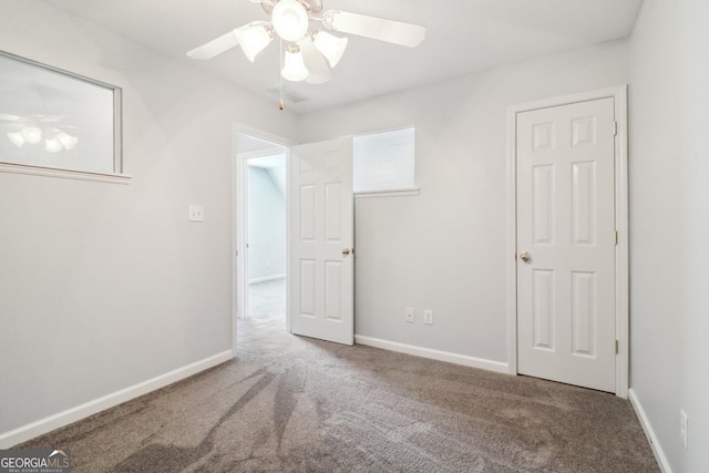 unfurnished bedroom featuring baseboards, carpet floors, and ceiling fan