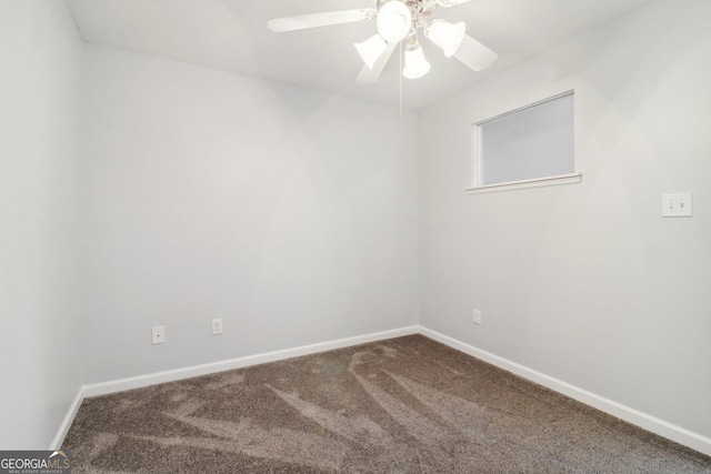 carpeted empty room with a ceiling fan and baseboards