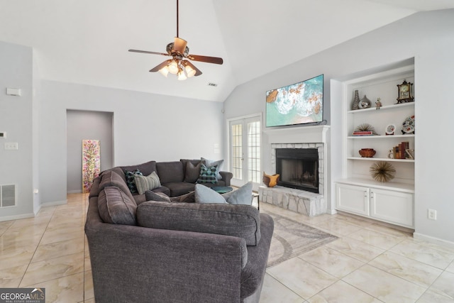 living room with vaulted ceiling, built in shelves, a ceiling fan, and visible vents