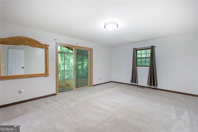 empty room with carpet and baseboards