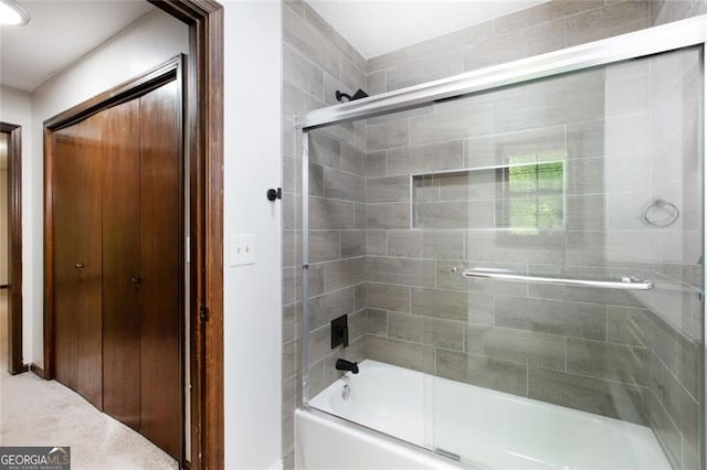 bathroom featuring bath / shower combo with glass door