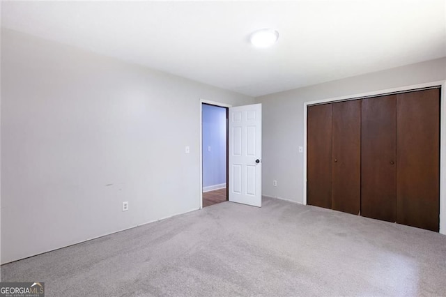 unfurnished bedroom with carpet and a closet