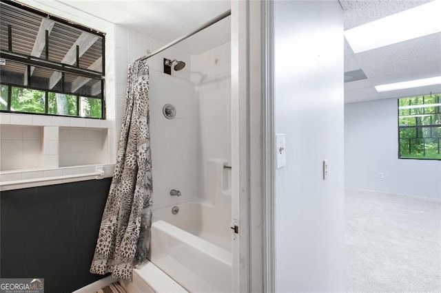 bathroom featuring shower / tub combo with curtain