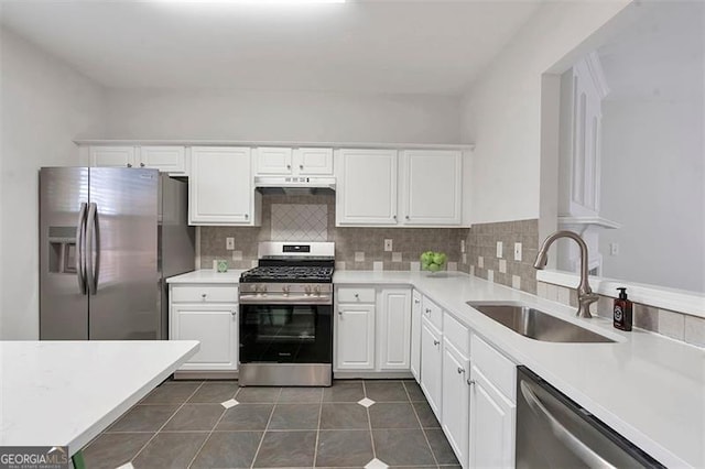 kitchen featuring a sink, stainless steel appliances, and white cabinets