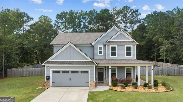 craftsman house with driveway, a porch, a front lawn, and fence