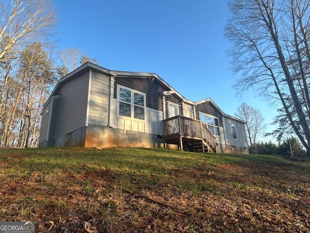 rear view of property featuring a yard and crawl space