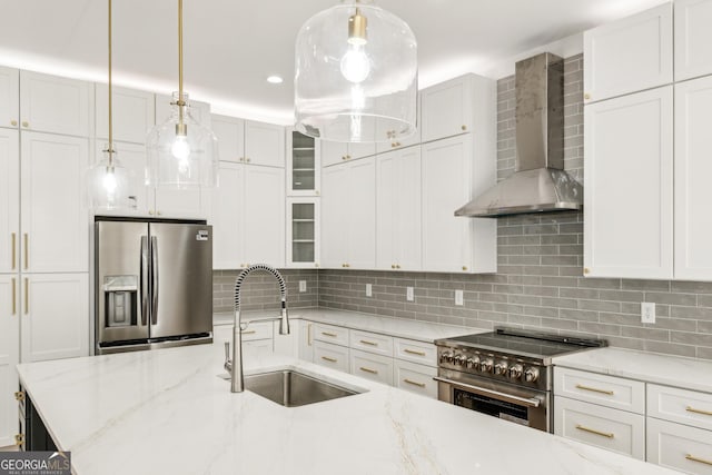 2611 Charlesgate Ave, Decatur, GA 30030 - kitchen featuring stainless steel appliances, a sink, wall chimney exhaust hood, decorative backsplash, and hanging light fixtures