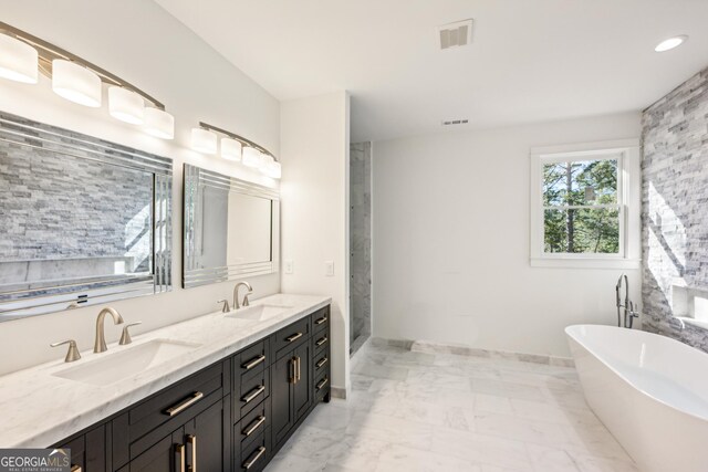 2611 Charlesgate Ave, Decatur, GA 30030 - bathroom with a freestanding bath, double vanity, marble finish floors, a stall shower, and baseboards